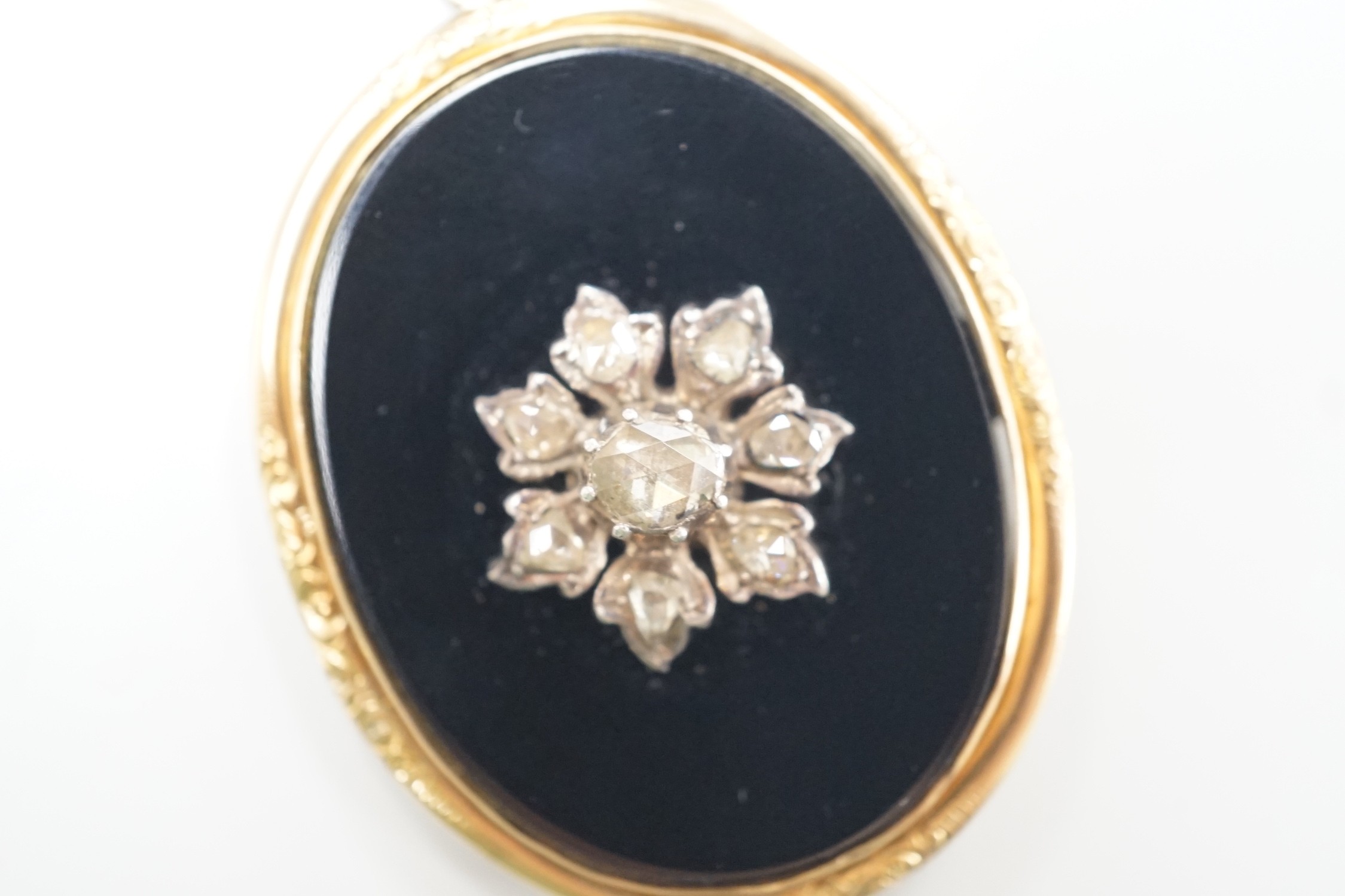 A Victorian yellow metal mounted, rose cut diamond set black onyx oval pendant, overall 56mm, gross weight 12.9 grams.